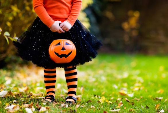 Little girl holding a plastic pumpkin