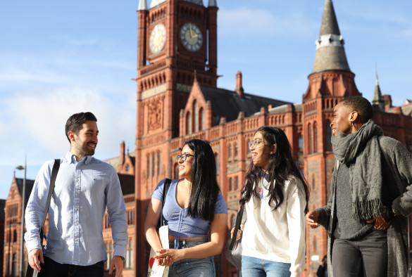 Four students chatting, Victoria Gallery and Museum in background