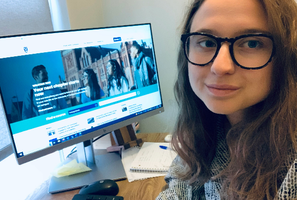 Picture of young woman sitting at a desk