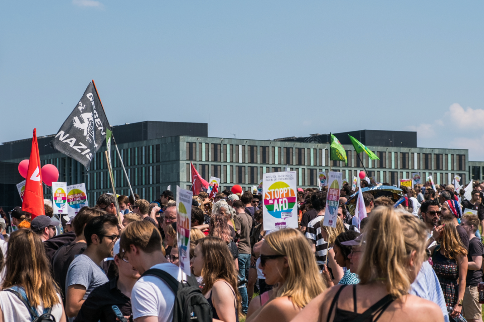 An anti AfD protest with people carrying banners in Germany