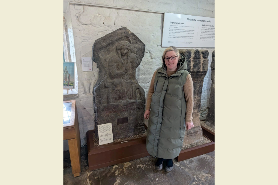 Charlotte Bell with the tombstone of Vedica at Ilkley Manor House