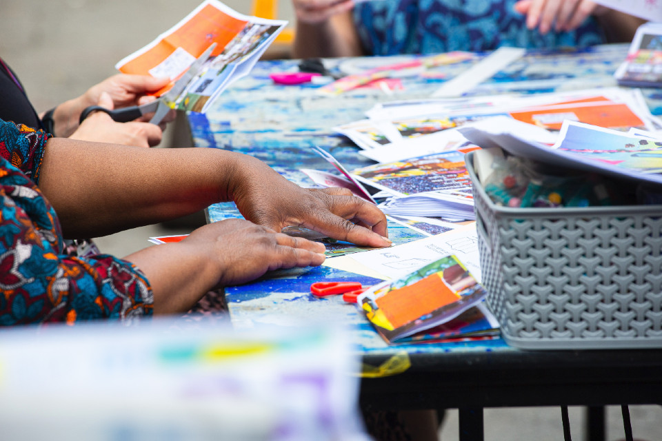 close up of participants hands working on zine